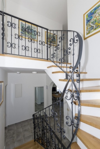 Indoor rustic metal stairs leading to the upper floor